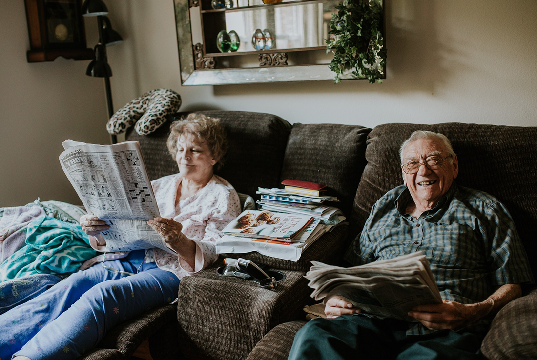 Elderly couple reading the newspaper